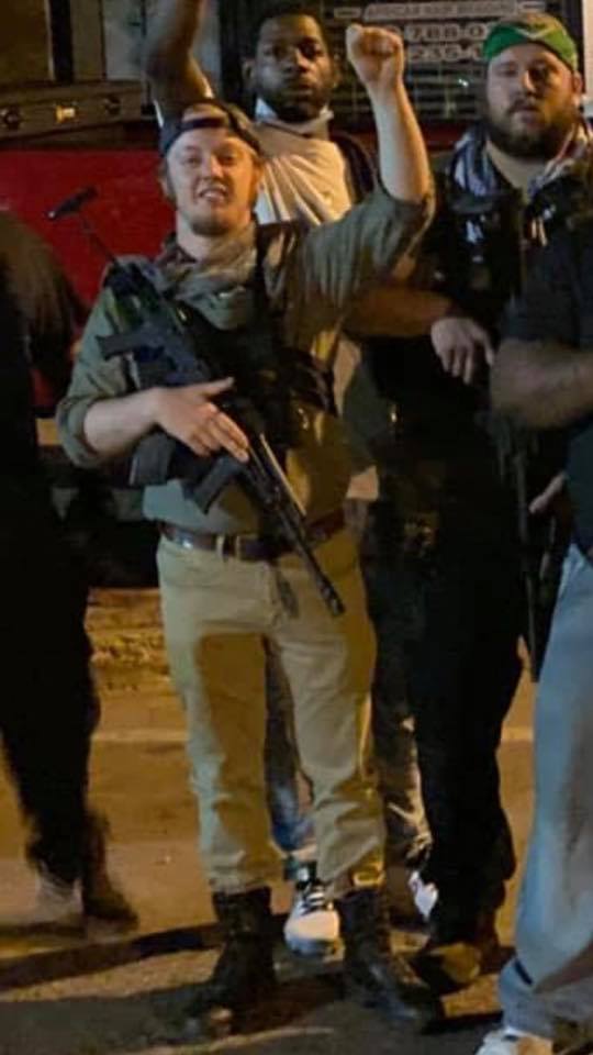 luke wenke holding an assault-style rifle and standing with boogaloo bois in minneapolis in 2020